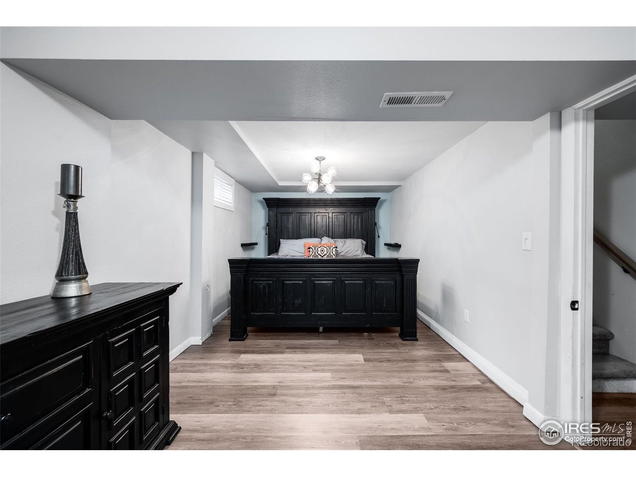 4175 South Inca Street Englewood, CO 80110 - Photo 19 of 29 a living room with a dresser and a wooden floor