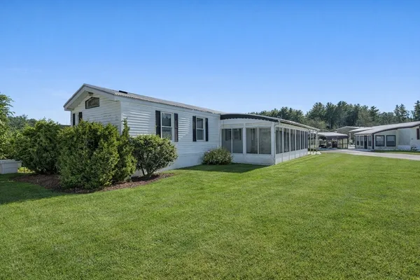 a front view of house with yard and green space
