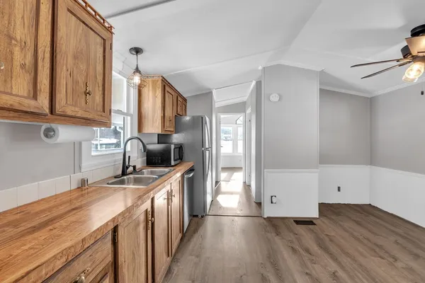 a kitchen with granite countertop a sink and a stove top oven