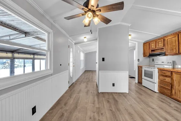 a view of a kitchen with a sink and a refrigerator