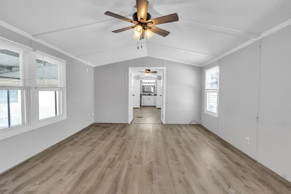 wooden floor in an empty room with a window