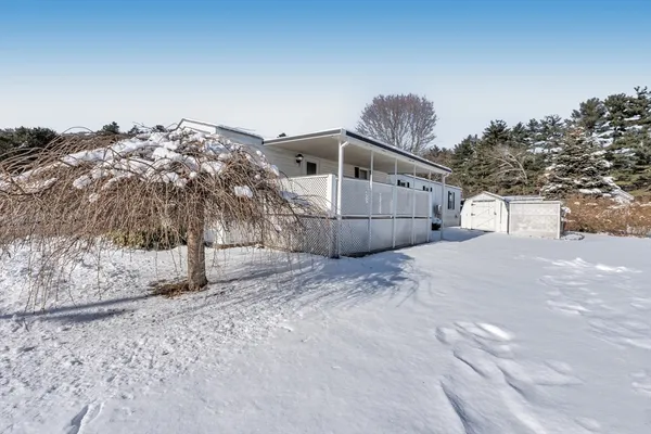 a view of a house with a snow in the yard