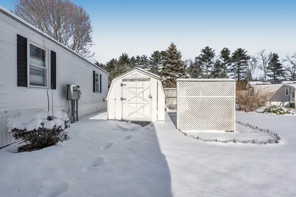 a view of a house with a snow in the yard