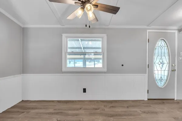 an empty room with fan and window