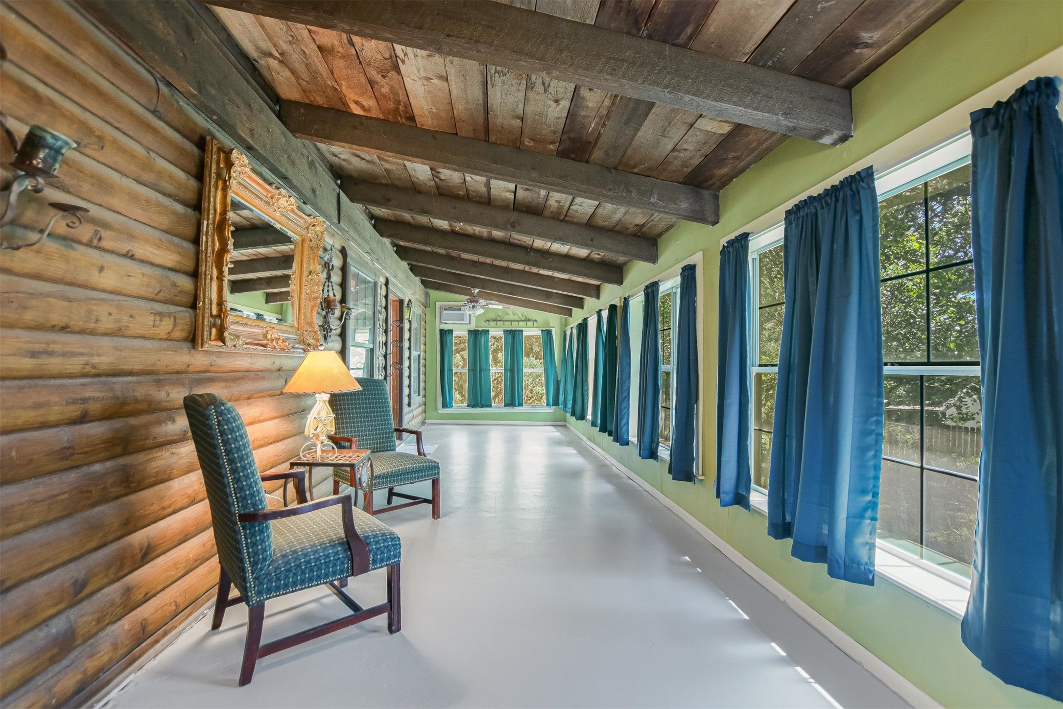 12711 Rr, Unit 12 Wimberley, TX 78676 - Photo 3 of 20 This bright sunroom at the front of the home offers a flexible space for morning coffee or a quiet reading nook