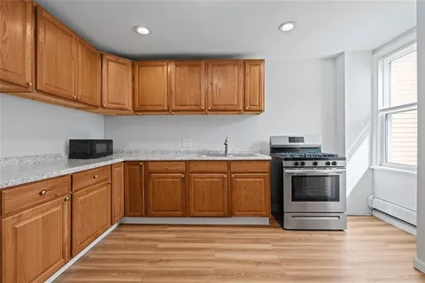 a kitchen with stainless steel appliances granite countertop a stove a sink and a refrigerator