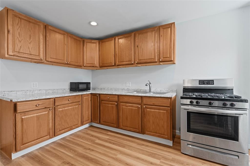 519 3rd Avenue Carnegie, PA 15106 - Photo 13 of 36 a kitchen with granite countertop cabinets stainless steel appliances and wooden floor