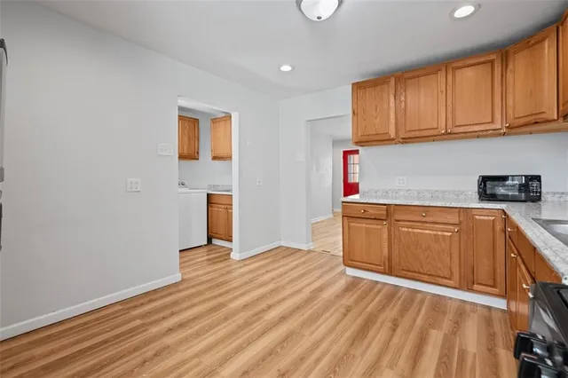 a kitchen with wooden floors and cabinets