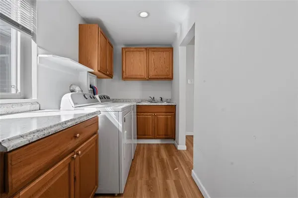 a kitchen with a sink cabinets and wooden floor
