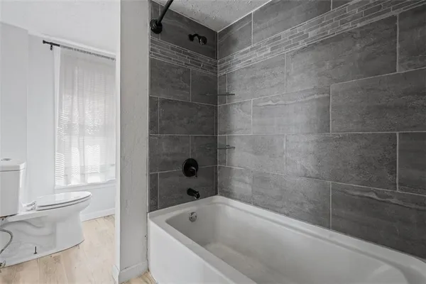 a bathroom with a bathtub and a toilet