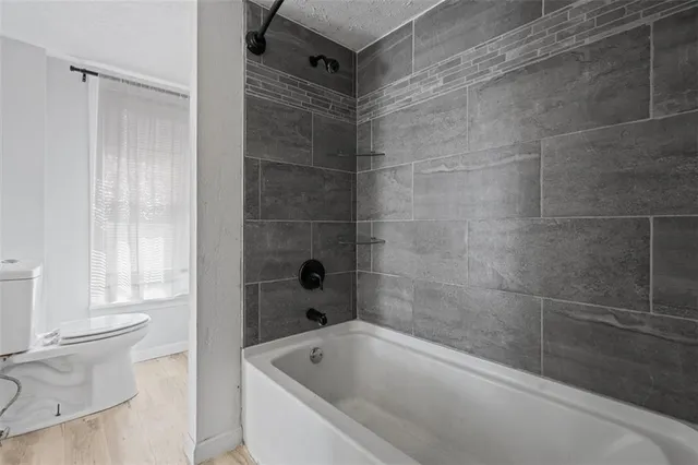 a bathroom with a bathtub and a toilet