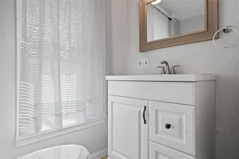 a bathroom with a sink vanity and toilet