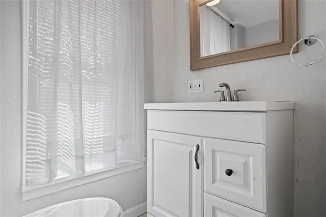 a bathroom with a sink vanity and toilet