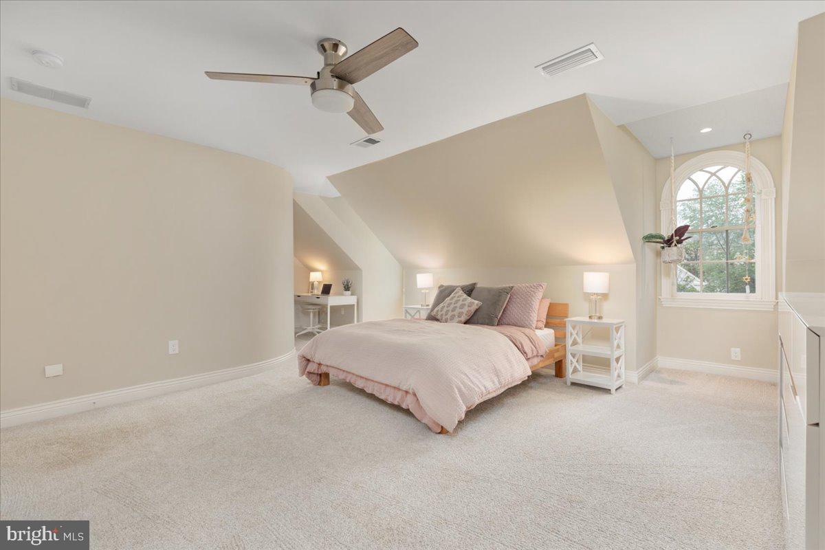14915 Alpine Bay Loop Gainesville, VA 20155 - Photo 38 of 105 a spacious bedroom with a bed and a chandelier
