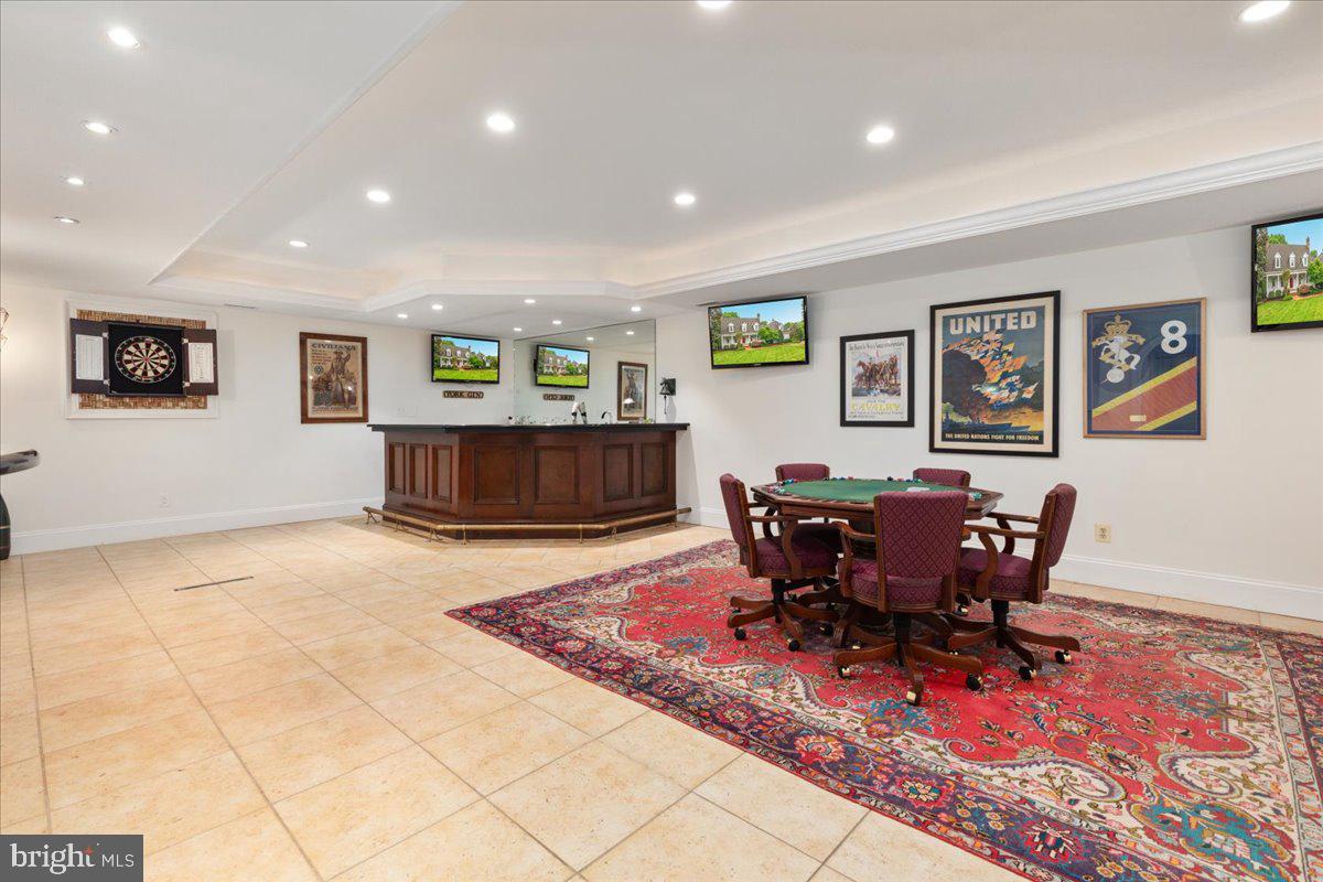 14915 Alpine Bay Loop Gainesville, VA 20155 - Photo 59 of 105 a living room with furniture a dining table and paintings on the wall