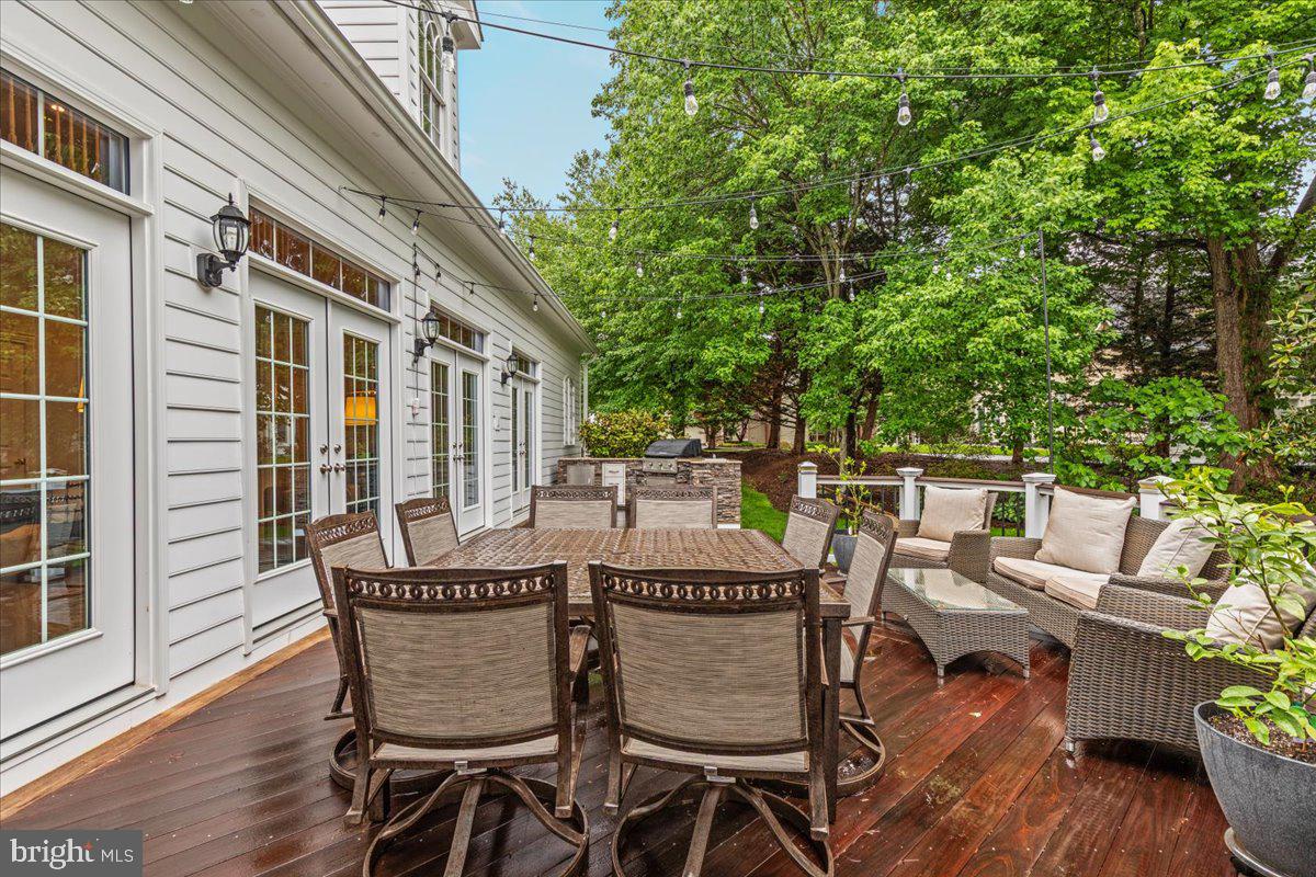 14915 Alpine Bay Loop Gainesville, VA 20155 - Photo 77 of 105 a view of a patio with table and chairs and wooden floor