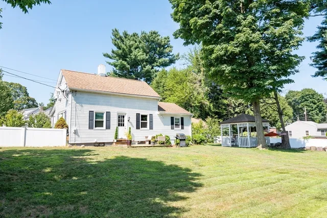 a front view of house with yard and trees around