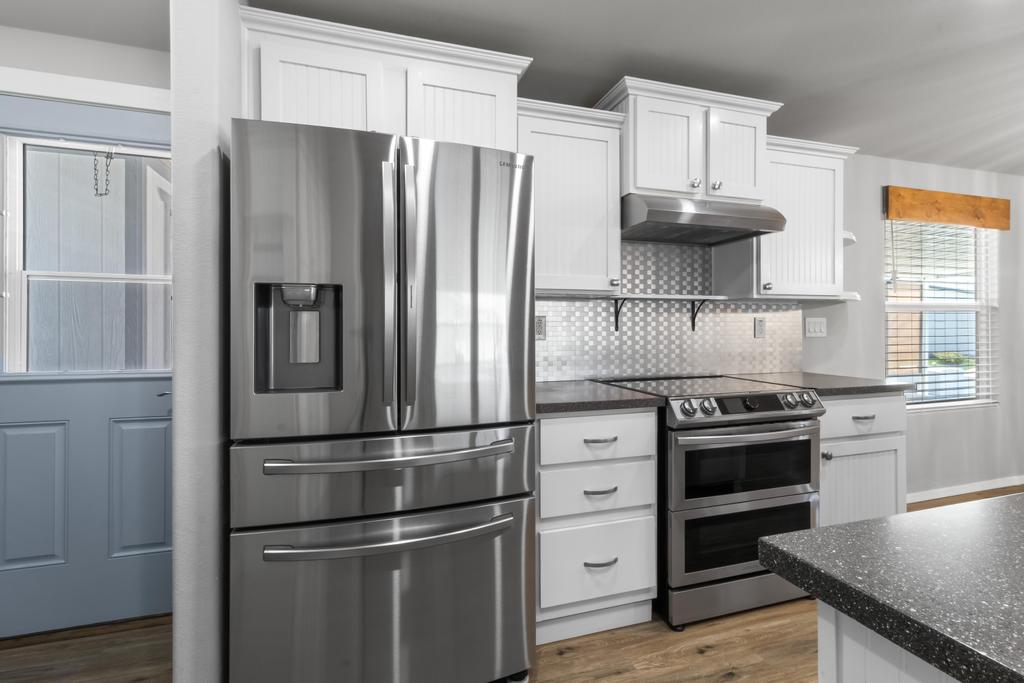 1545 East El Rodeo Road, Unit 42 Fort Mohave, AZ 86426 - Photo 23 of 45 a kitchen with stainless steel appliances a refrigerator stove and sink