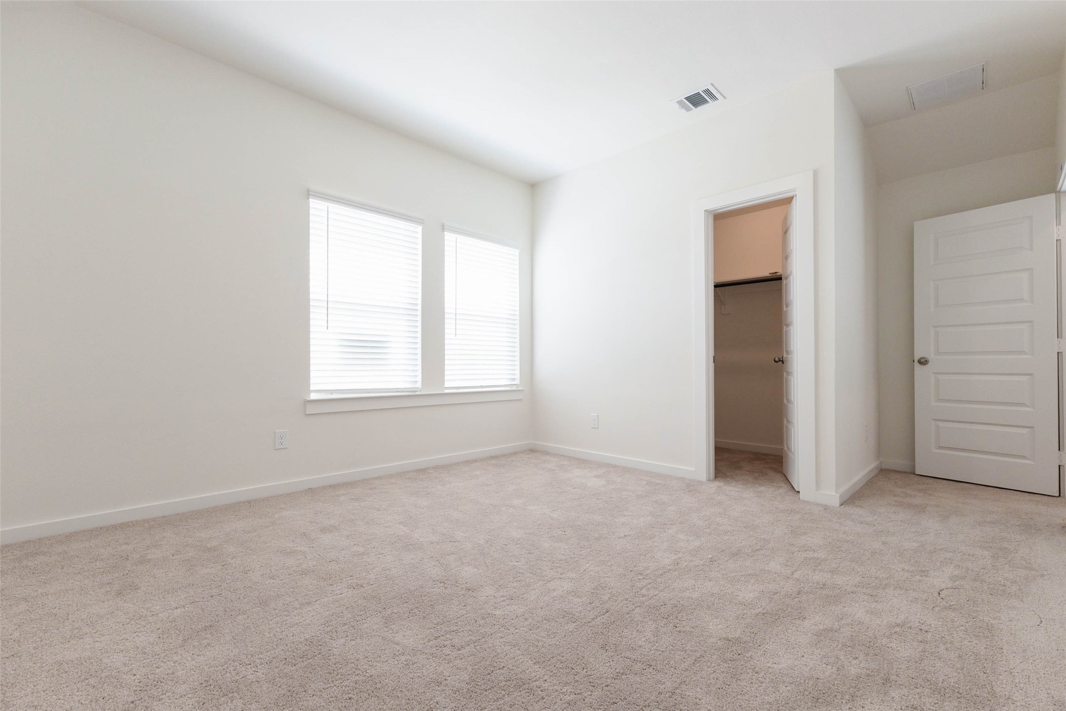 1115 Santee Court Rosharon, TX 77583 - Photo 19 of 23 This carpeted bedroom has two windows with blinds that fill the room with soft light, and a doorway to a closet. The neutral walls make it easy to decorate. It is a flexible space for a bedroom, guest room, nursery or home office with room for a desk and storage.