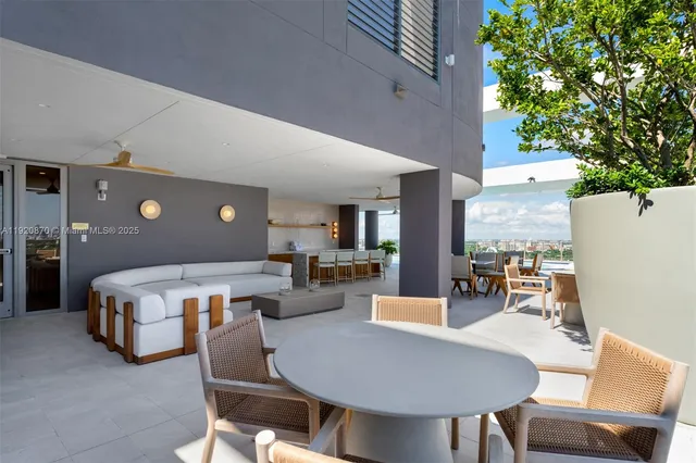 a living room with a large window with table and chairs