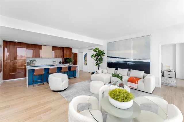 a living room with furniture and a kitchen area