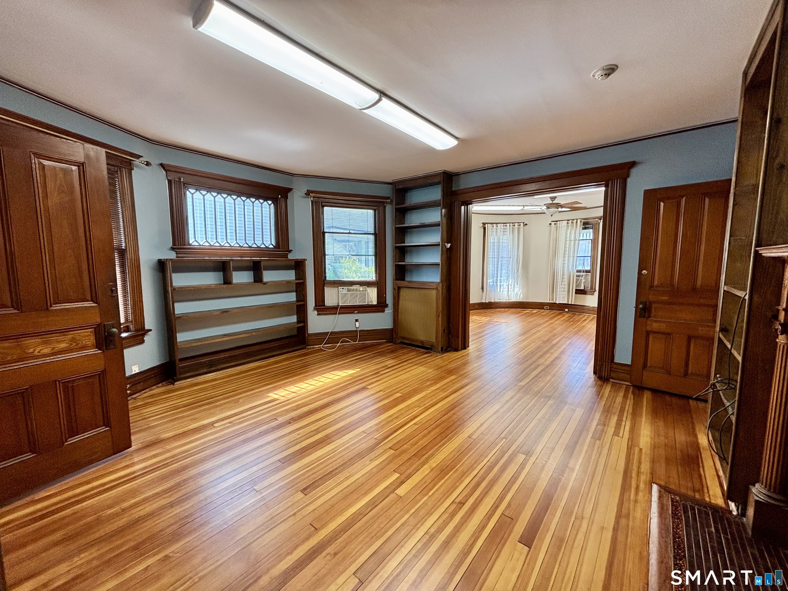 wooden floor in an empty room with a window