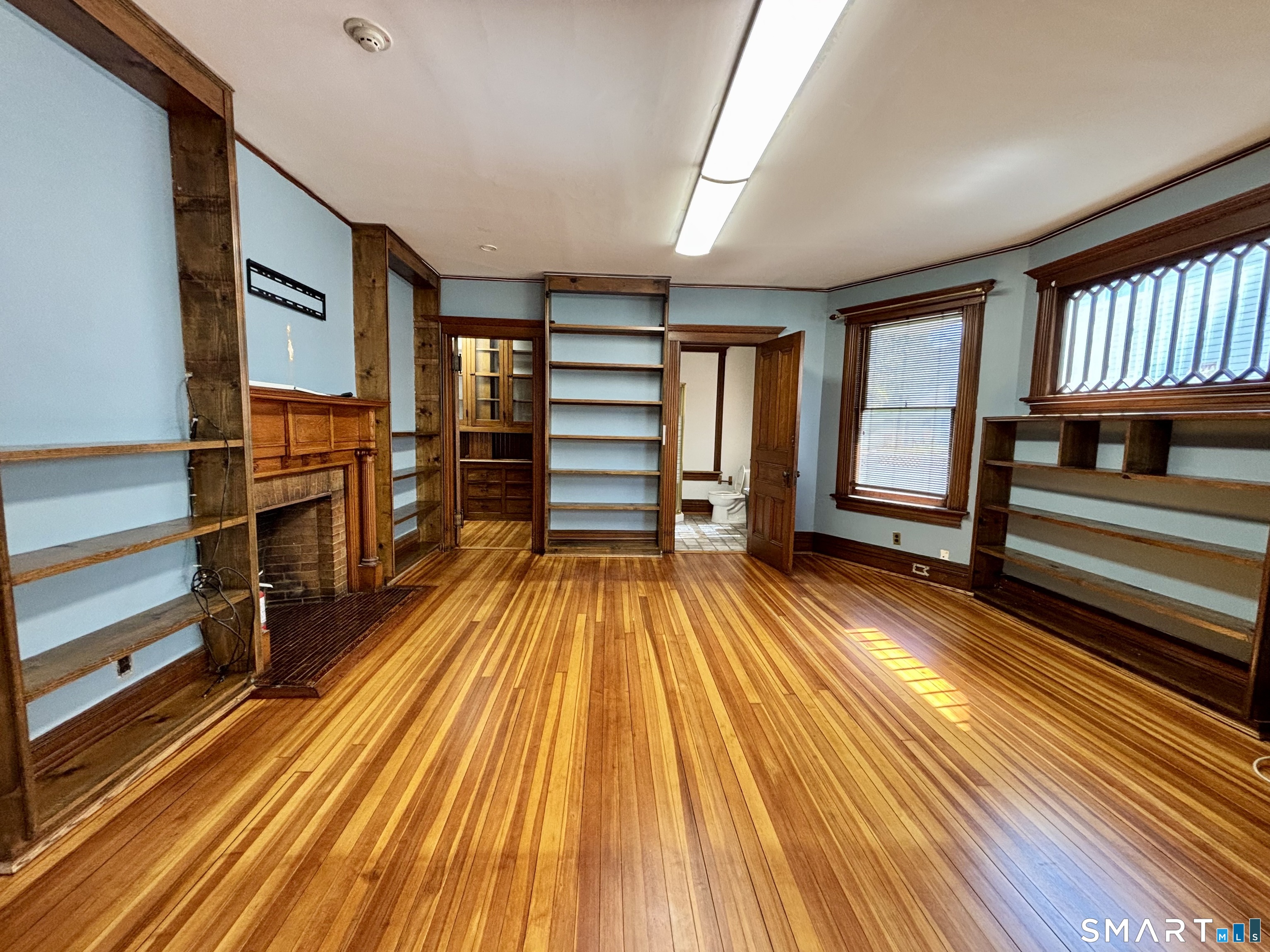 1887 Summer Street Stamford, CT 06905 - Photo 2 of 6 a view of a room with wooden floor and furniture