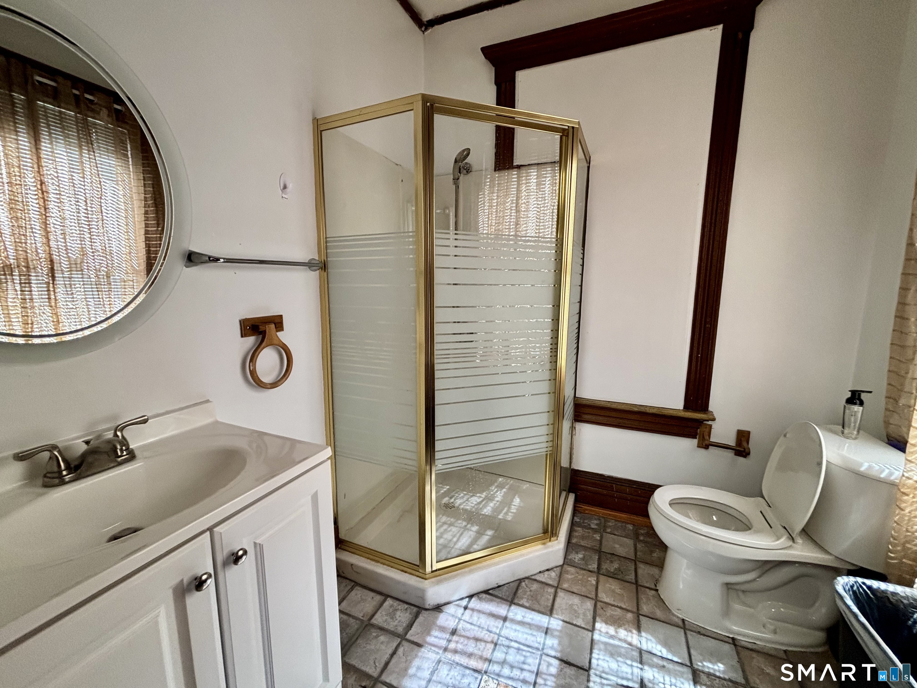 1887 Summer Street Stamford, CT 06905 - Photo 4 of 6 a bathroom with a sink and a mirror