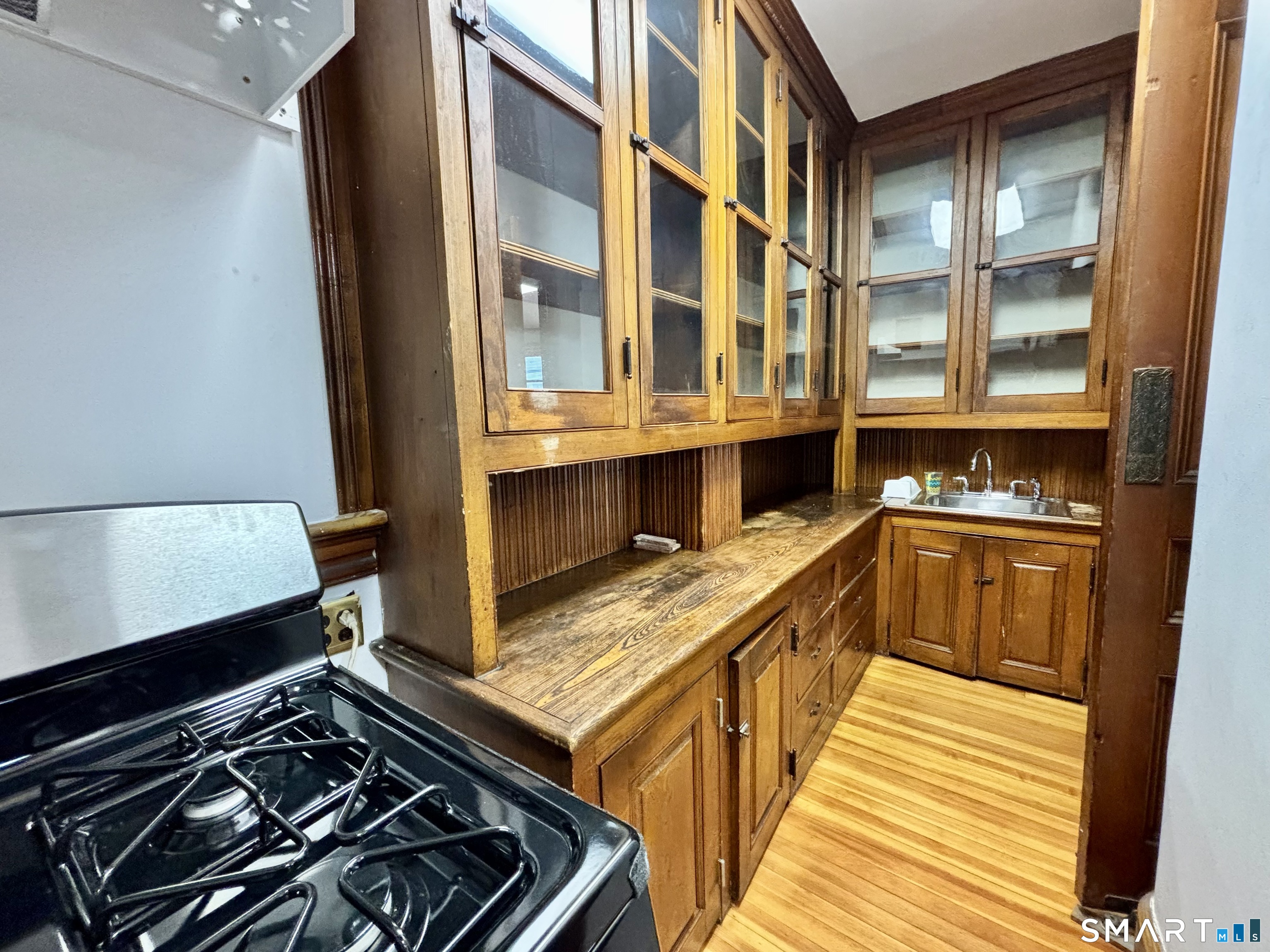 1887 Summer Street Stamford, CT 06905 - Photo 5 of 6 a kitchen with stove and cabinets