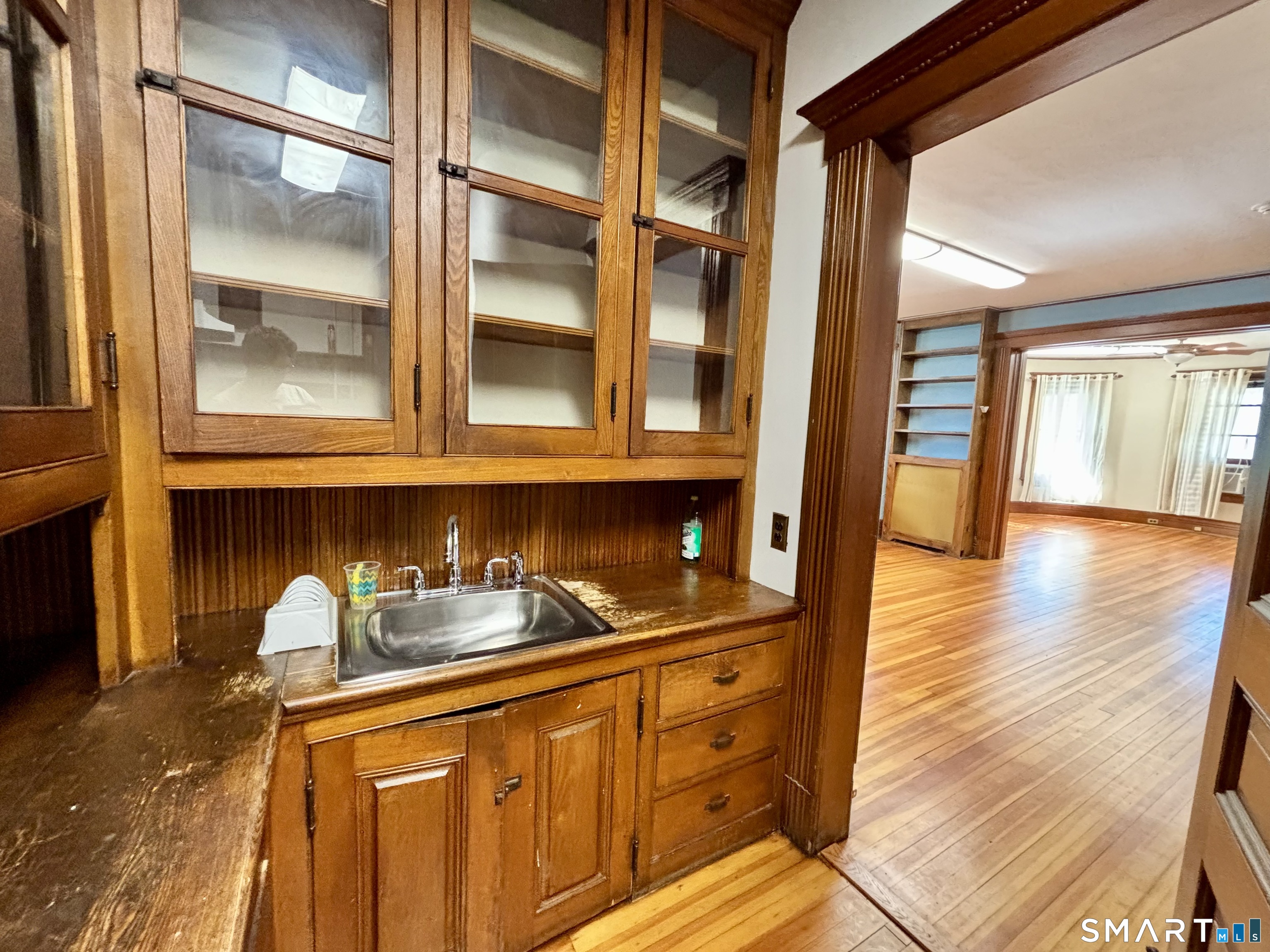 1887 Summer Street Stamford, CT 06905 - Photo 6 of 6 a kitchen with granite countertop white cabinets and wooden floor