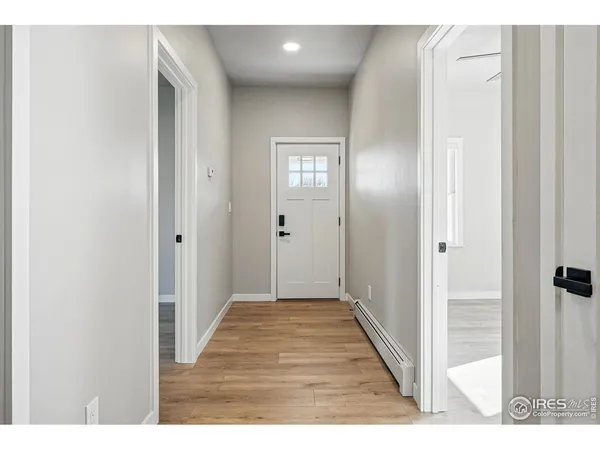 a view of a hallway with wooden floor