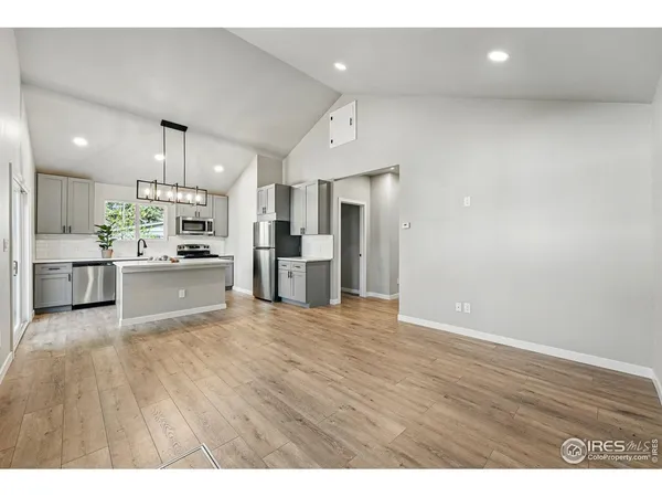 a view of a kitchen with a refrigerator and a sink