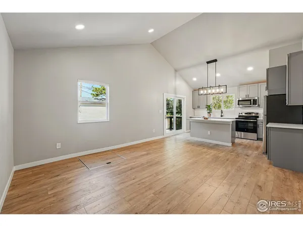 a kitchen with granite countertop a sink and cabinets