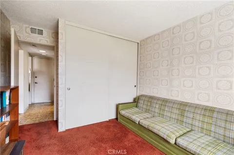 a spacious bedroom with a bed and a couch