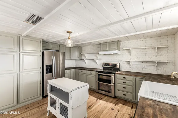 a kitchen with cabinets and stainless steel appliances