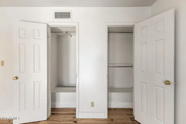 a view of walk in closet with wooden floor