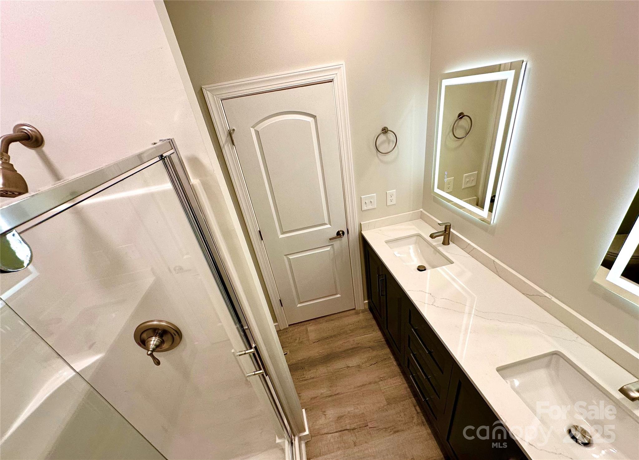 1171 Peach Orchard Road Jefferson, SC 29718 - Photo 17 of 30 a bathroom with a double vanity sink a mirror and shower