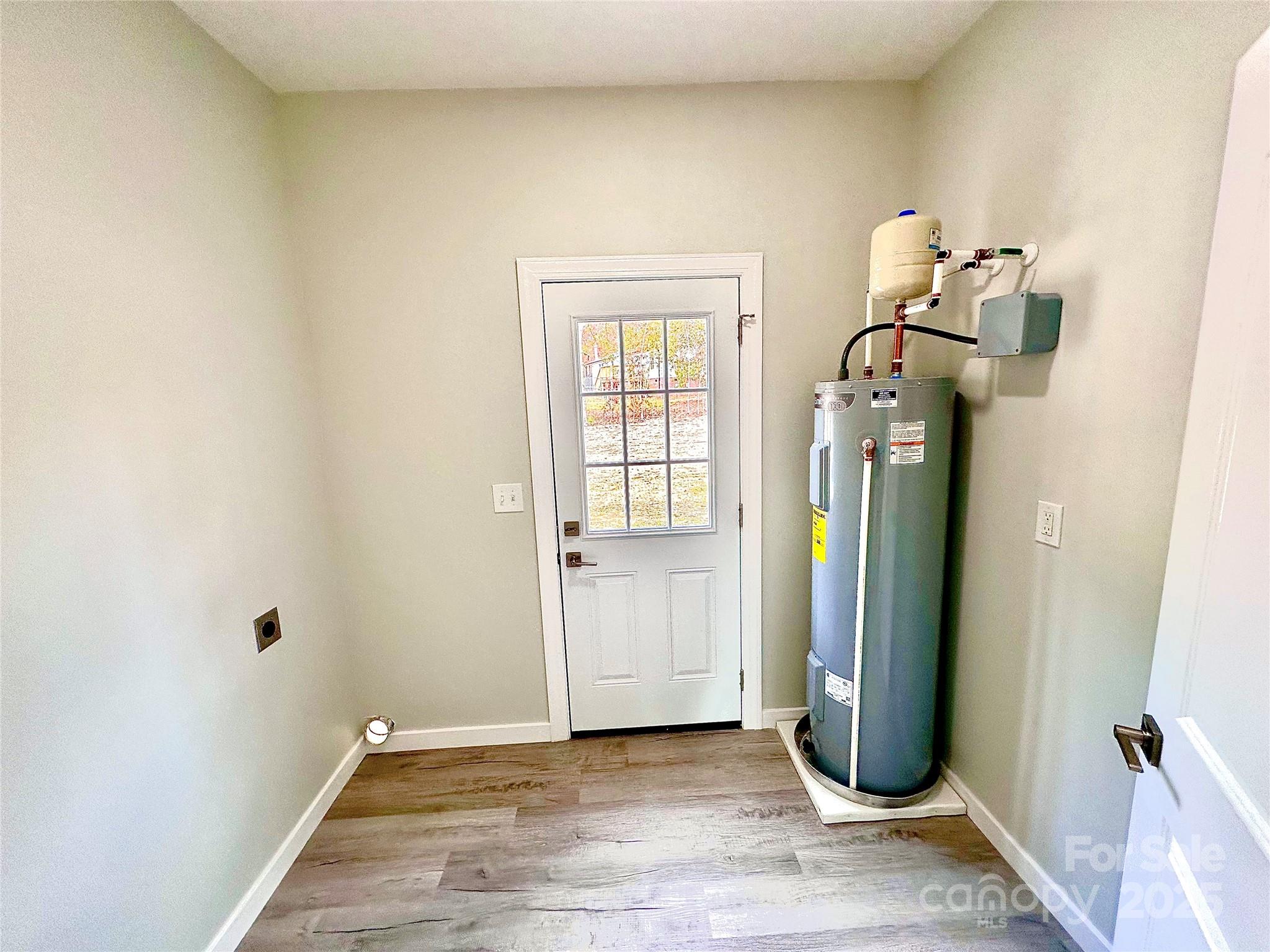 1171 Peach Orchard Road Jefferson, SC 29718 - Photo 9 of 30 a view of a hallway with wooden floor and a bathroom
