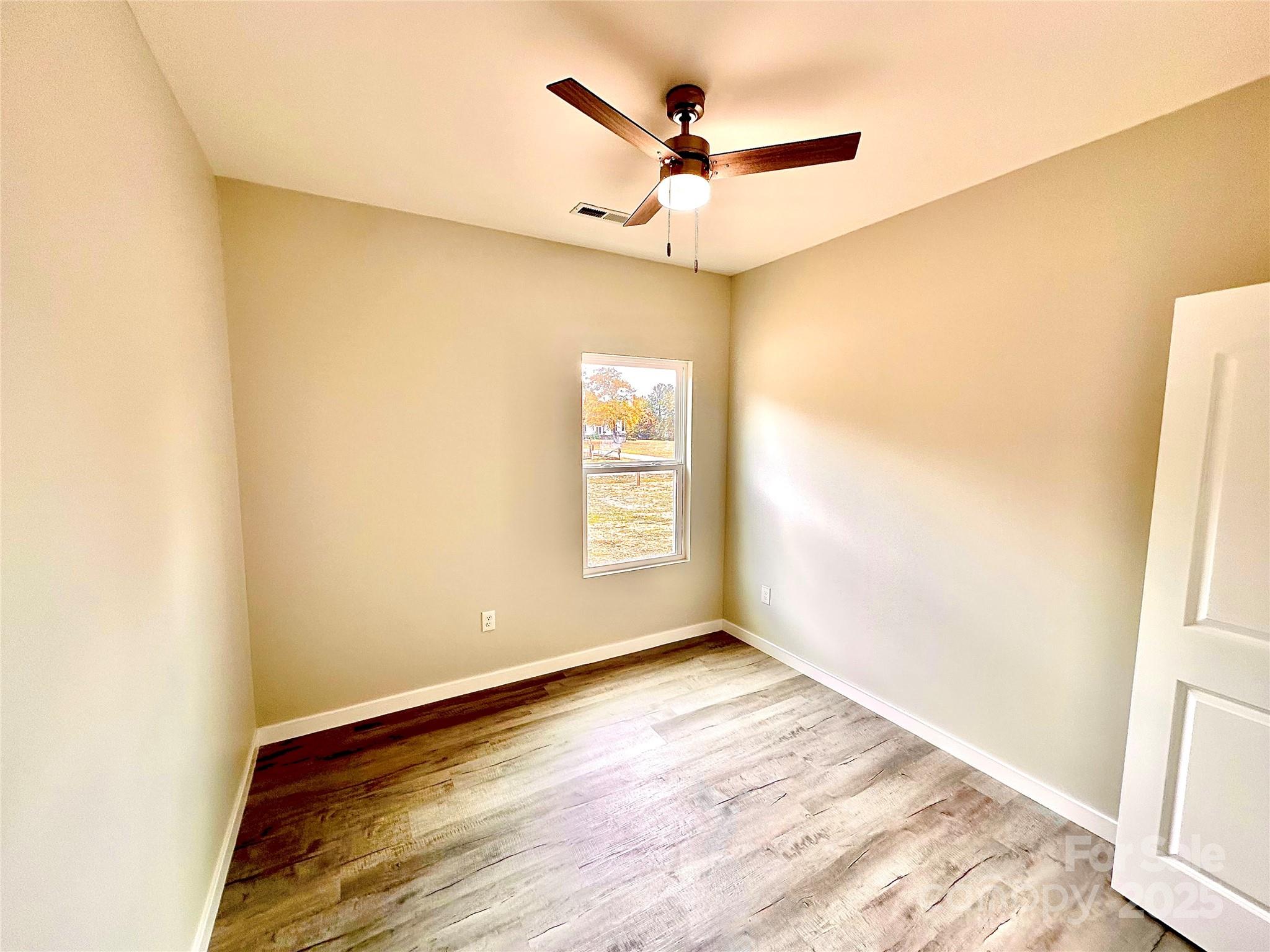 1171 Peach Orchard Road Jefferson, SC 29718 - Photo 10 of 30 a view of a big room with wooden floor and a window