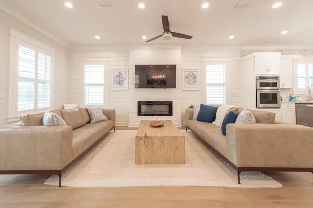 a living room with couches and a chandelier