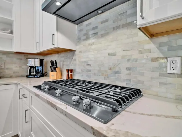 a bedroom with a bed and a flat tv screen on dresser