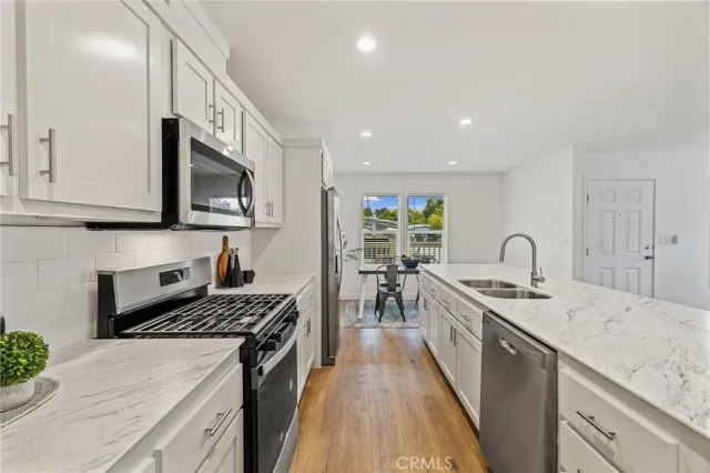 a kitchen with a sink stove and cabinets