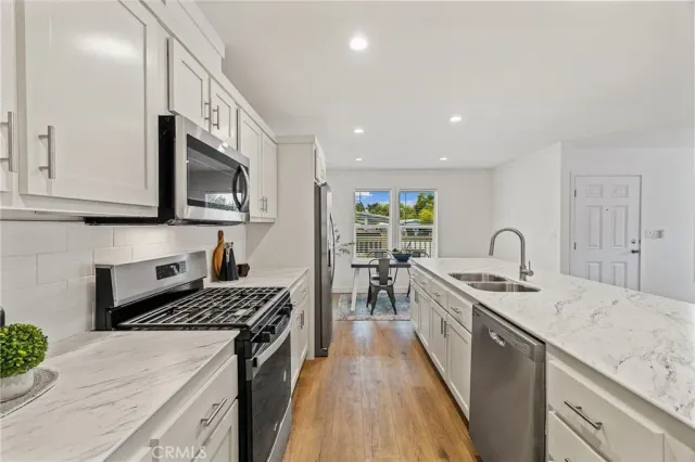 a kitchen with a sink stove and cabinets