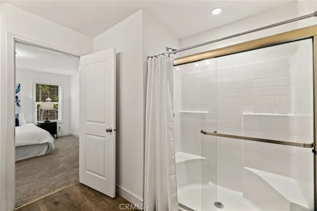a bathroom with a glass shower door