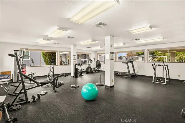 a room with gym equipment and large window