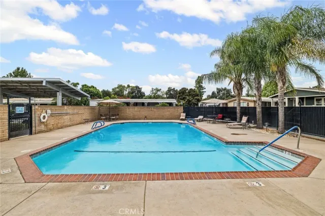 a view of backyard with swimming pool and outdoor seating