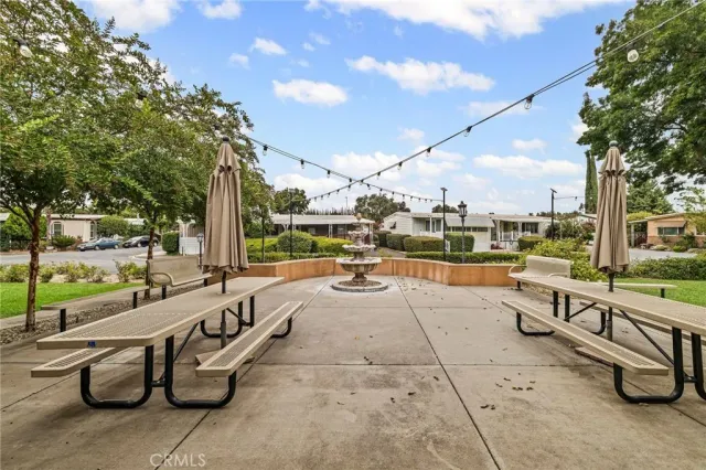 a swimming pool with outdoor seating and patio