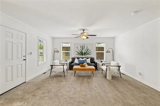 a living room with furniture and chandelier