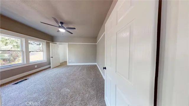 an empty room with windows and closet