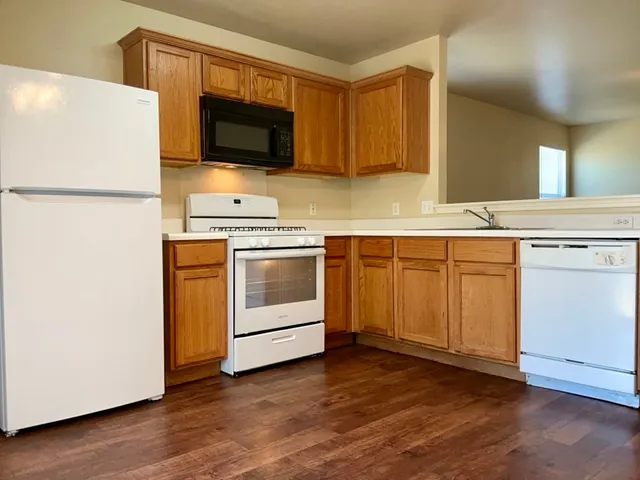 a kitchen with a sink appliances and cabinets